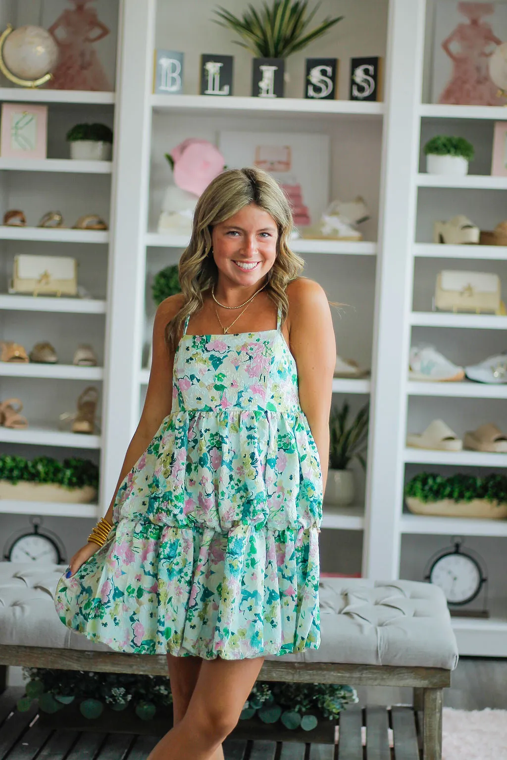 Floral printed, spaghetti strap dress with tiered bubble hem and a smocked back detail.